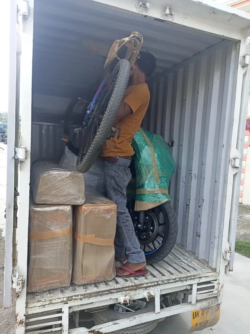 Agarwal Packers and Movers truck being loaded with packed household goods in Dehradun