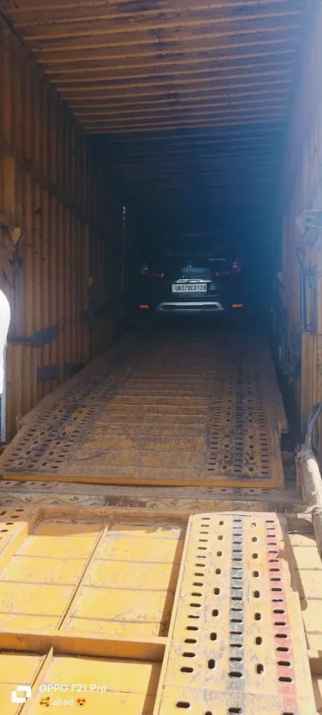 A vehicle secured inside an enclosed carrier for transport from Dehradun by Agarwal Packers and Movers