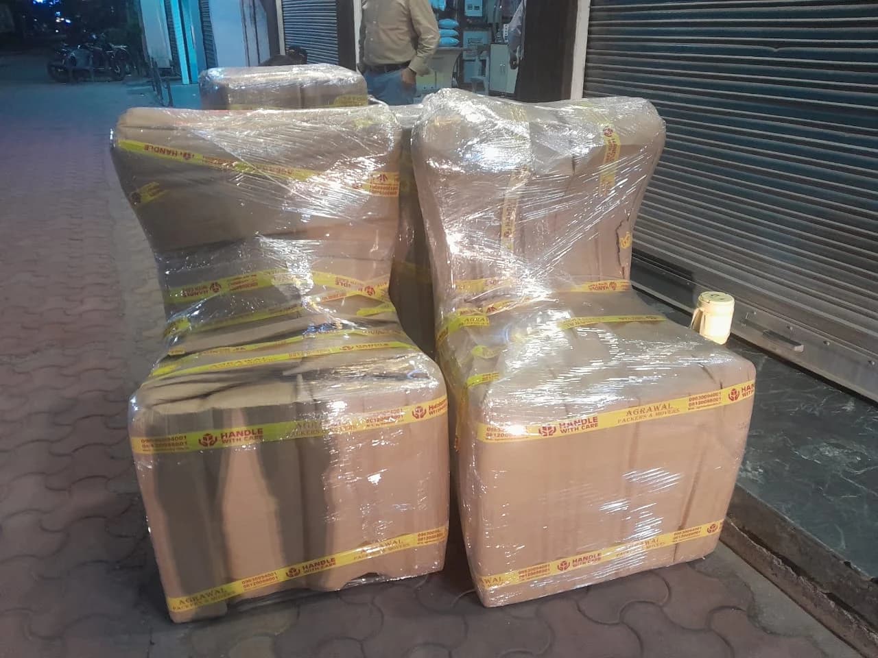 Household goods stretch-wrapped and strapped, packed and ready for storage by Agarwal Packers and Movers